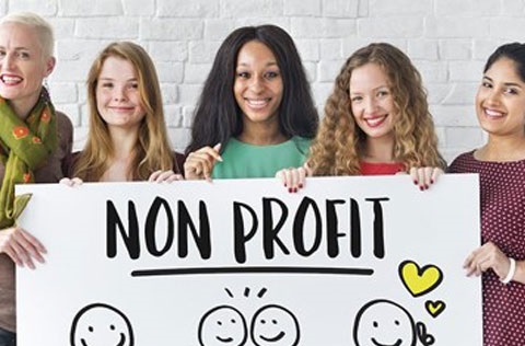 People holding a sign about non-profit information.