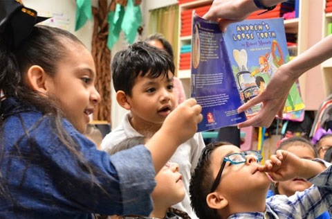 Kids looking at a book