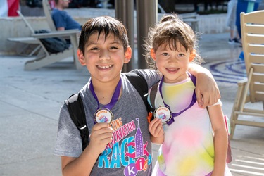 Kids holding medals with the amazing preservation race