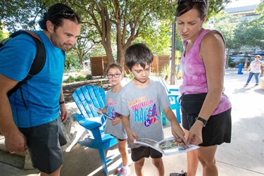 A mother and Father helping their son along the amazing preservation race