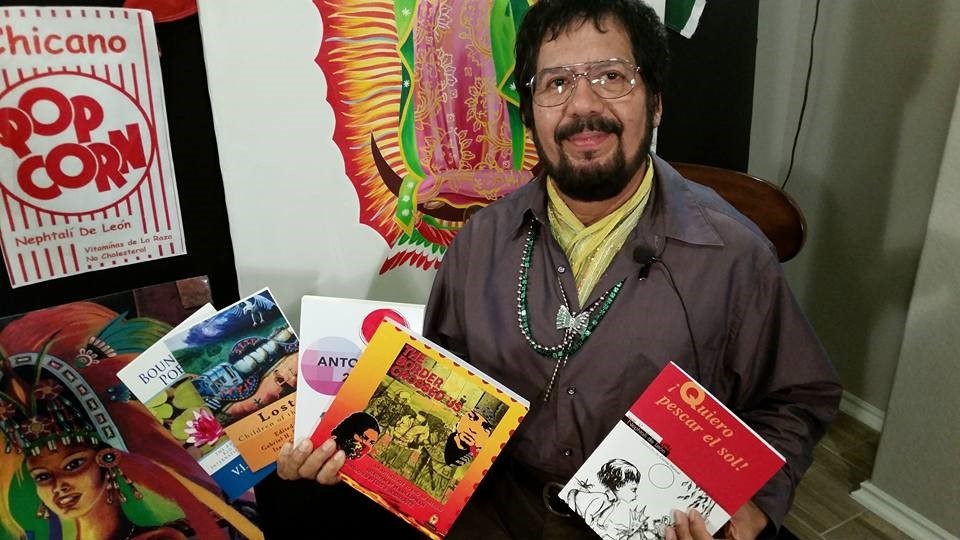 Nephtali de leon holding books of poetry
