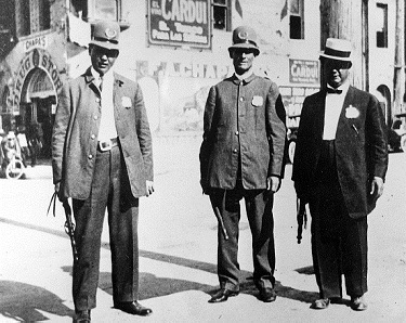Gray-uniformed SAPD officers outside the Market (c. 1900).