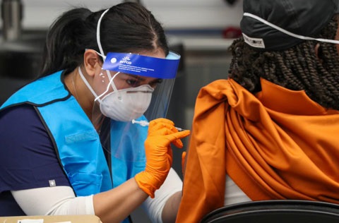 Nurse giving a vaccine shot to someone