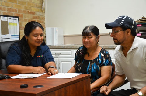 People looking at utility assistance program documents.