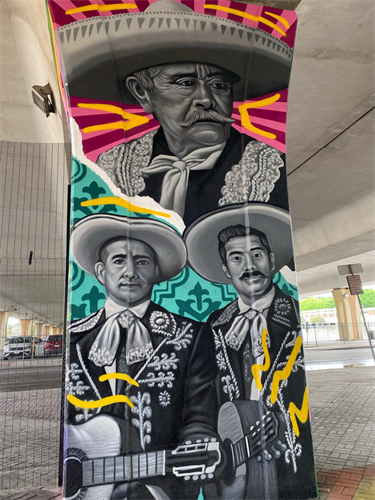 Historic musical performers are represented in the mariachi trio and Conjunto musicians.