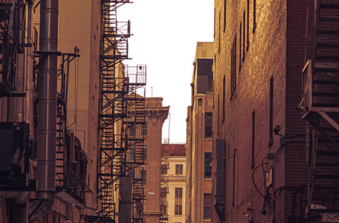An alley between tall buildings.