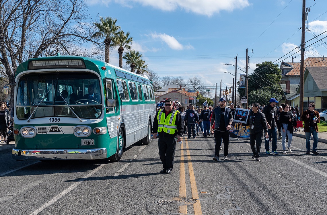 MLK March participants and green bus.