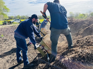Volunteers prep ground for planting