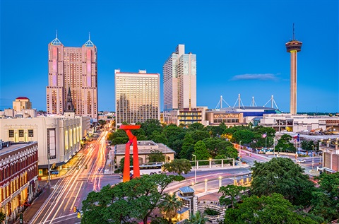 A vibrant city street featuring a variety of buildings, showcasing urban architecture.