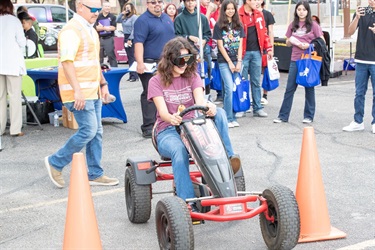 Student driving cart with impaired goggles at Municipal Court Week