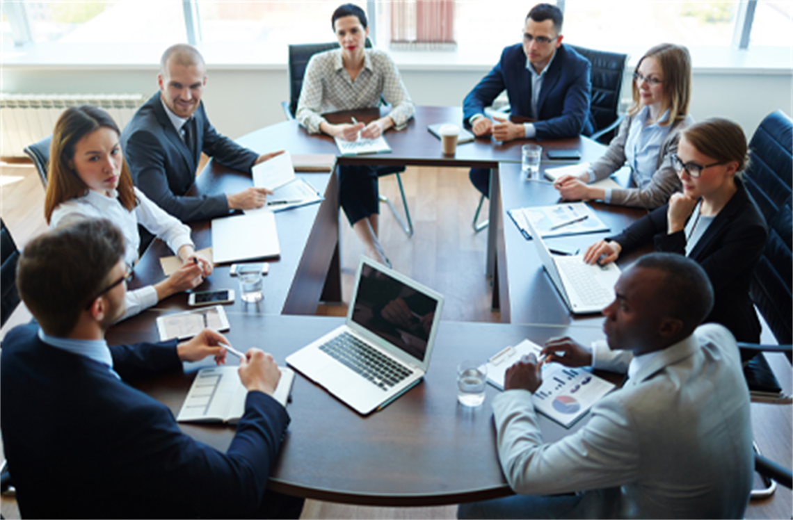 People sitting around a table in a meeting