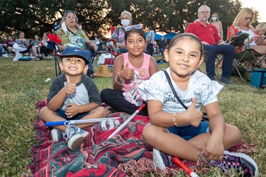 Children sitting in the grass.