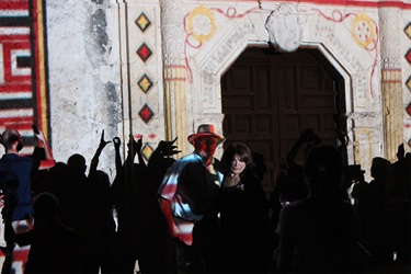 People taking photos of Mission San José up near the front door.