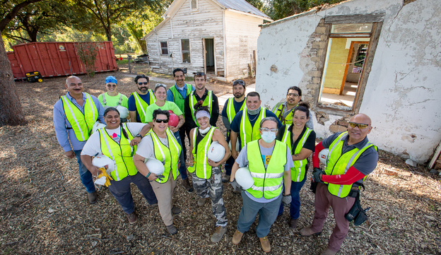 Group of employees wearing yellow vests.