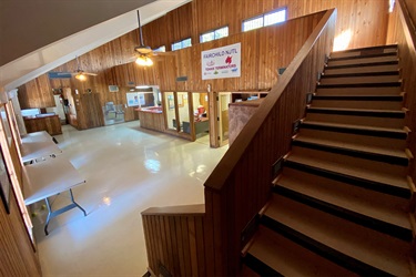 Spacious room with a focus on a staircase leading up to the second floor.