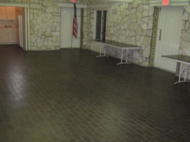 A spacious room with two tables.