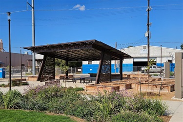 Covered pavilion with picnic tables and benches underneath.