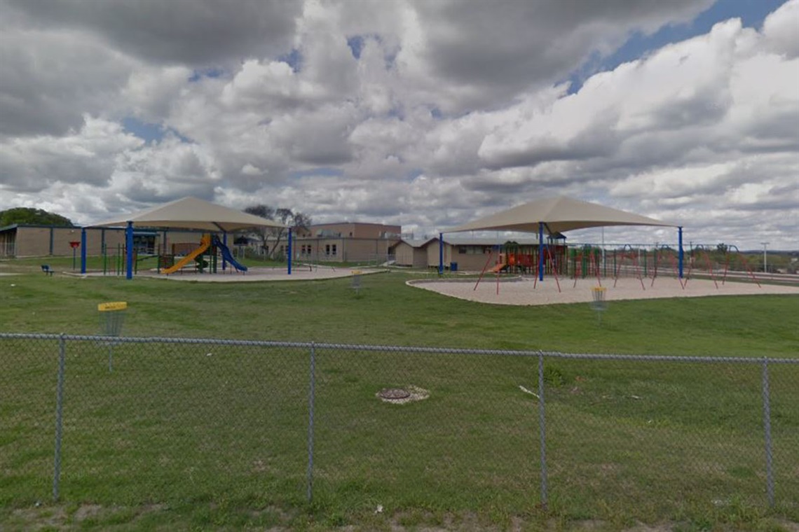 Two covered playgrounds located in sand