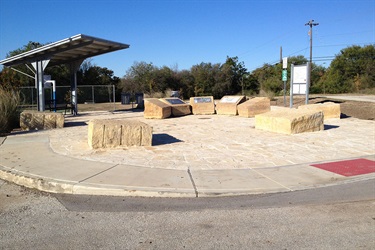Stones aligned in a semi-circle with some plaques attached