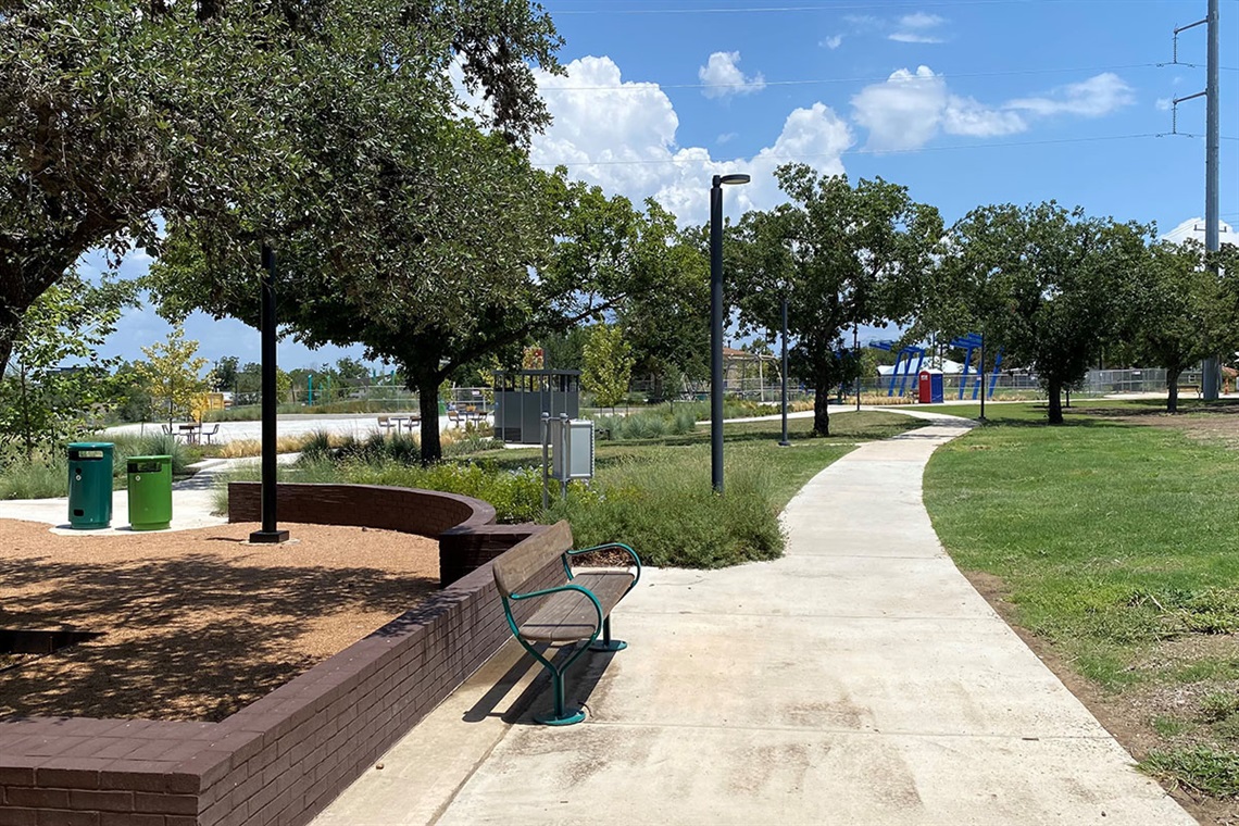 Bench, paved walkway and trees
