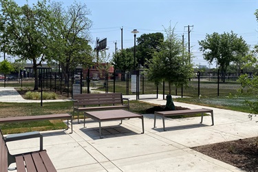 Wooden benches and tables on a paved walkway