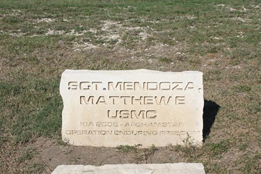 An inscribed stone monument of Sgt. Mendoza, Matthew E. KIA 2008 - Afghanistan Operation Enduring Freedom.