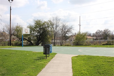 Walkway leading to a basketball court.