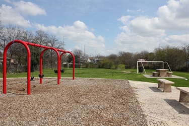 Playground with swings and benches.