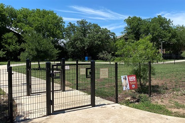Entrance gate with small dog park sign.
