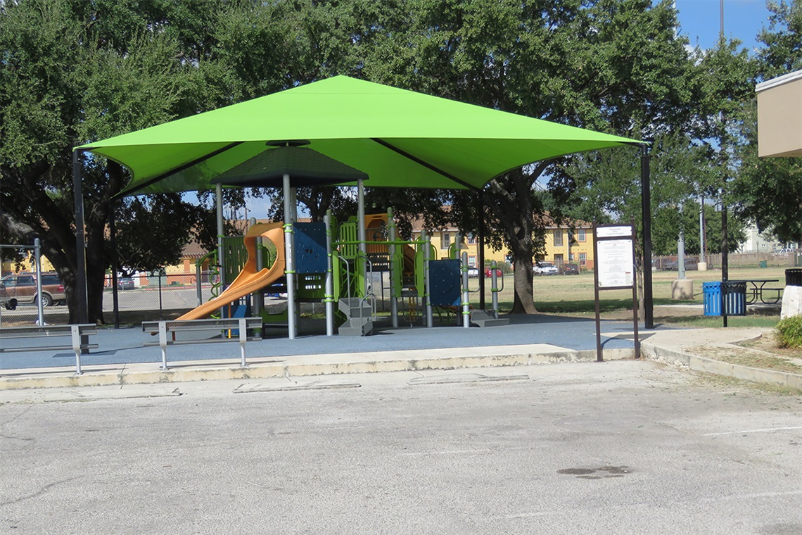 Green canopy shades playground equipment.