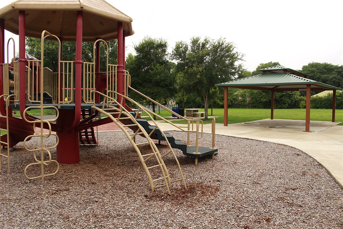 A playground with a slide and play structure.