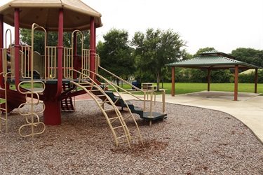 A playground with a slide and play structure.