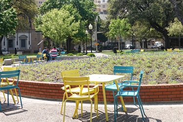 Tables and chairs surrounded by a garden