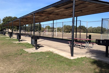 A baseball field with picnic tables