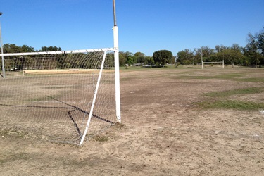 A soccer goal standing in a field