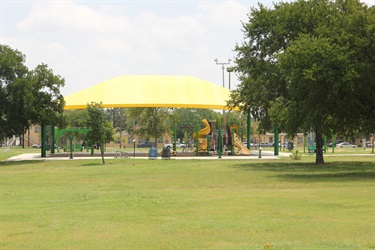 Field in forefront with playground in background