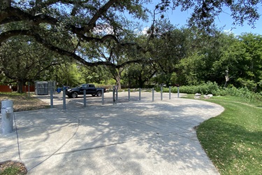 A vehicle parked amidst trees in a parking lot