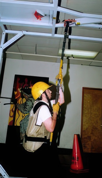 Firefighter candidate uses Pike pole and ceiling breach & pull device during CPAT event.