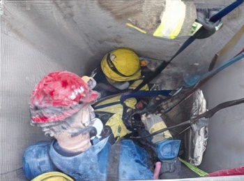 Firefighter candidates crawl on hands and knees through a tunnel maze during Search CPAT event.