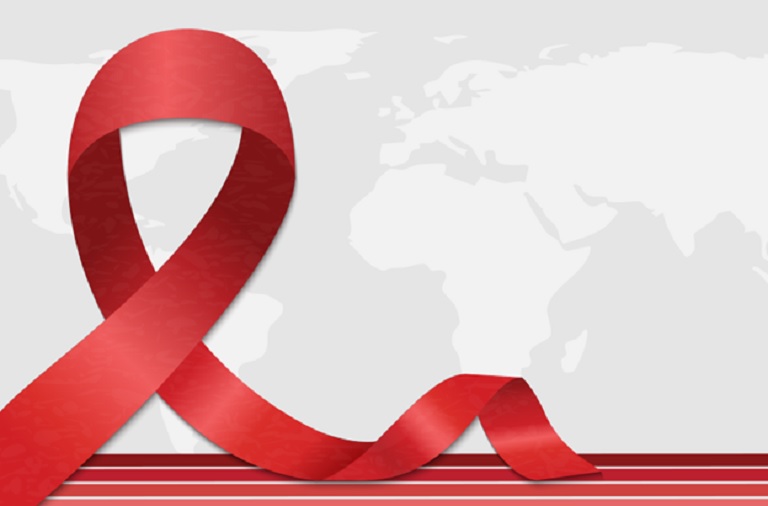 Man sitting on a couch using a glucose meter to check his blood sugar level.