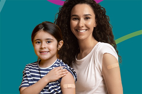 Woman and child with rolled up sleeves, showing bandages on their arms.