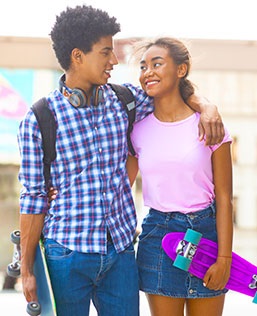Teen boy and teen girl walking together