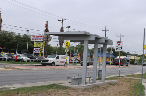 Picture of a bus stop near a side road