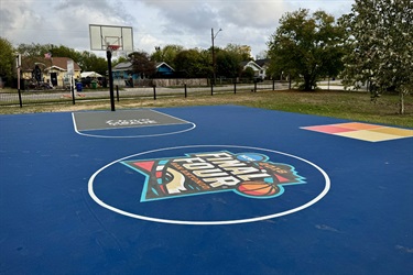 A basketball court featuring the 2018 Final Four logo prominently displayed at center court.