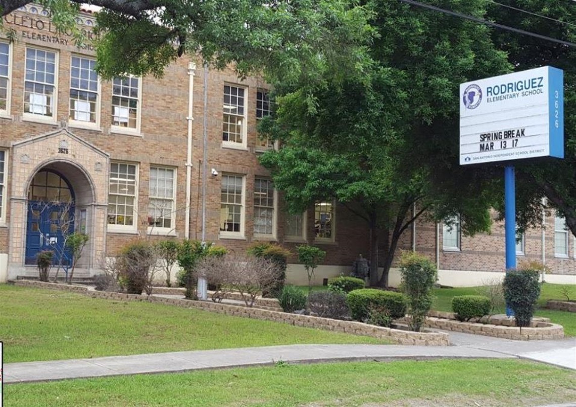 A school building with a sign on the front.