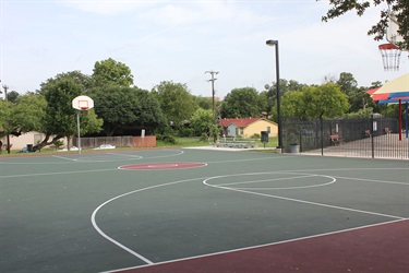Outdoor basketball court with bleachers