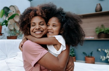 Mother hugging her daughter.