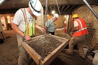 Man using sand sifter.