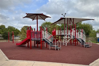 Two red slides with stairs and a canopy.