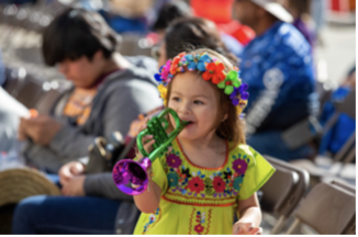 a little girl playing with a toy trumpet